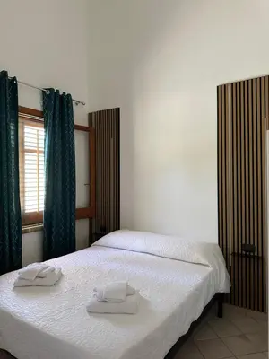 a bedroom with a bed with two towels on it at Cocciu D'amuri Home - Scopello in Scopello
