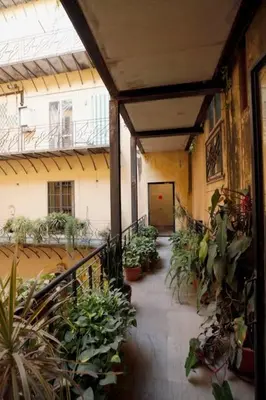 a hallway with a bunch of potted plants in a building at Porto Felice Home Palermo in Palermo