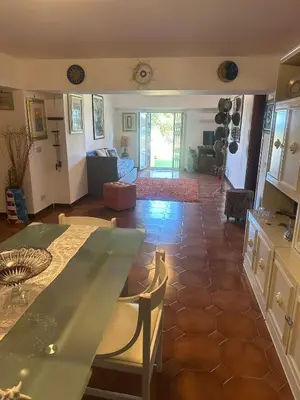 a kitchen and living room with a table and chairs at La Terrazza del Sole in Lido di Mondello