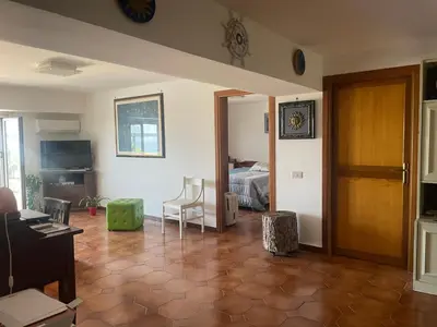 a living room with a room with a bed at La Terrazza del Sole in Lido di Mondello