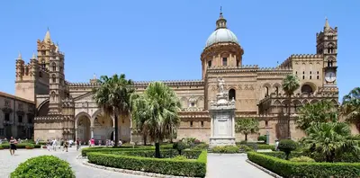 a large building with a garden in front of it at Pinhouse Apartment in Palermo