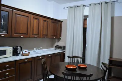 a small kitchen with a table and a microwave at Pinhouse Apartment in Palermo