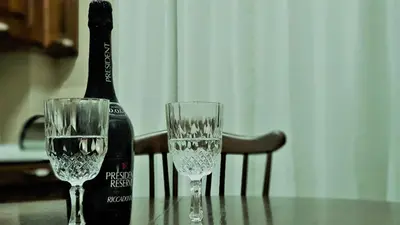 a bottle of champagne and two glasses on a table at Pinhouse Apartment in Palermo