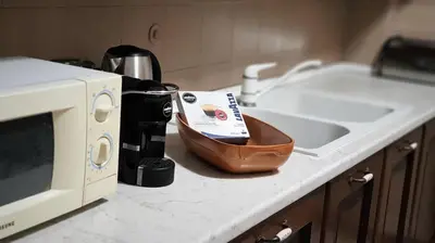 a kitchen counter with a microwave and a bowl on it at Pinhouse Apartment in Palermo