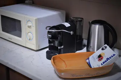 a microwave sitting on a counter next to a coffee maker at Pinhouse Apartment in Palermo
