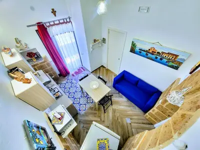an overhead view of a living room with a blue couch at Seafront House Gabbiano Blu in Santa Flavia