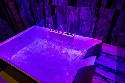 a purple bath tub in a room with purple lighting at SUPREME Suite&Spa in Palermo