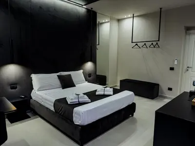 a bedroom with a large bed with two towels on it at SUPREME Suite&Spa in Palermo