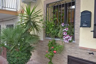 a building with a window with plants and flowers at B&B Jolly house Bolognetta in Bolognetta
