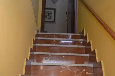 a set of stairs with a view of a door at B&B Jolly house Bolognetta in Bolognetta