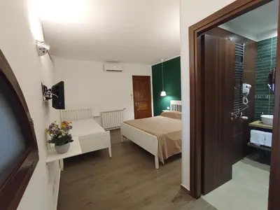 a small room with a bed and a bathroom at Casa di Lele in Carini