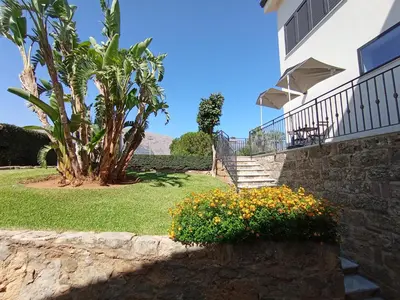 a house with stairs and flowers in a yard at Casa di Lele in Carini