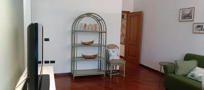 a wooden table with chairs and food on it at Casa vacanze Donna Paolina in Bagheria