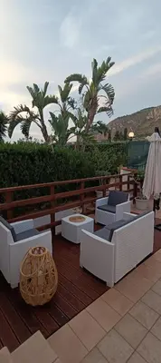 a patio with chairs and chairs on a deck at Casa vacanze Donna Paolina in Bagheria