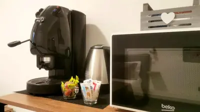 a coffee maker sitting next to a computer monitor at Palermo dream Rooms in Palermo