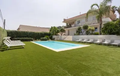 a yard with a swimming pool and chairs and a house at Villa Dwellings With Pool For Exclusive Use in Alcamo