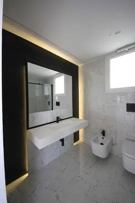 a bathroom with a sink and a toilet and a mirror at Villa Dwellings With Pool For Exclusive Use in Alcamo