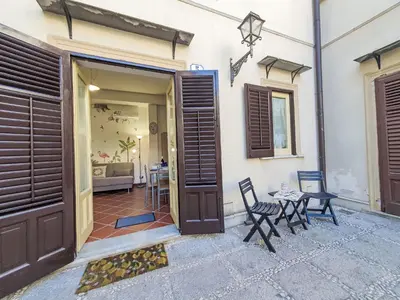 a door to a house with two chairs and a table at Holiday Home Maya's Home Palermo by Interhome in Palermo