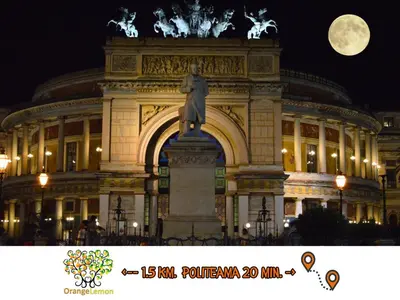 a building with a statue in front of it at night at Orange Lemon Garden Palermo in Palermo