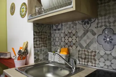a kitchen with a sink and a counter top at Orange Lemon Garden Palermo in Palermo