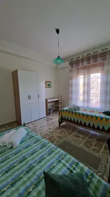 a bedroom with two beds and a window at Casa vacanza-Il Sole di Sicilia in Vita