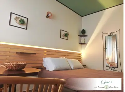 a bedroom with a bed and a table and a mirror at Domus Amelio - Country Rooms in Cinisi