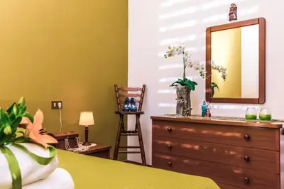 a bedroom with a dresser and a mirror at Casa Dorotea in Balestrate