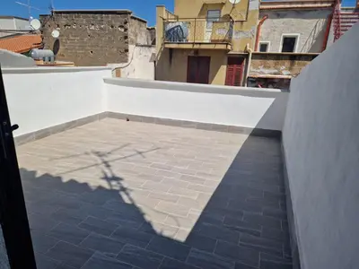 a shadow of a building on a balcony at Il Cavaliere Apartment in Capaci