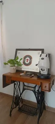 a desk with a sewing machine on top of it at Metro 171 Loft in Palermo