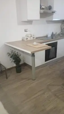 a kitchen with a wooden counter top in a room at Metro 171 Loft in Palermo