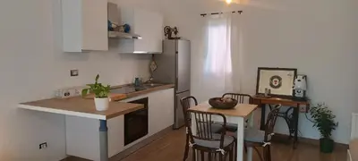 a kitchen with a counter and a table with chairs at Metro 171 Loft in Palermo