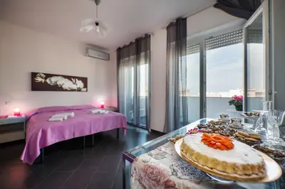 a room with a bed and a table with food on it at Bed and Breakfast Palermo Centro in Palermo