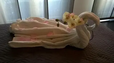 a pile of towels and flowers on a bed at Bed and Breakfast Palermo Centro in Palermo