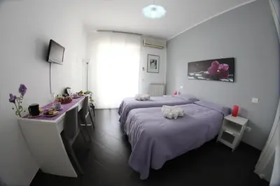 a bedroom with a bed and a desk and a window at Bed and Breakfast Palermo Centro in Palermo