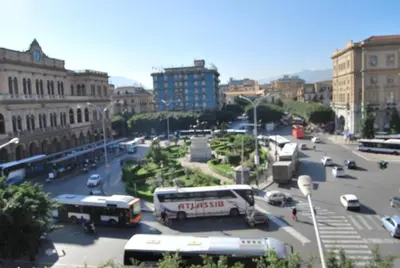 a city with buses and cars on a street at Bed and Breakfast Palermo Centro in Palermo