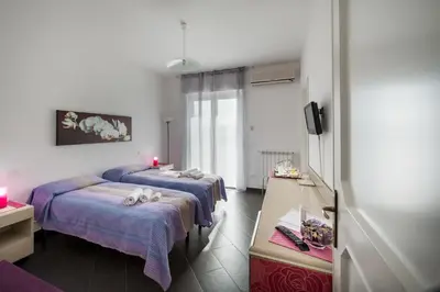 a room with three beds in a room at Bed and Breakfast Palermo Centro in Palermo