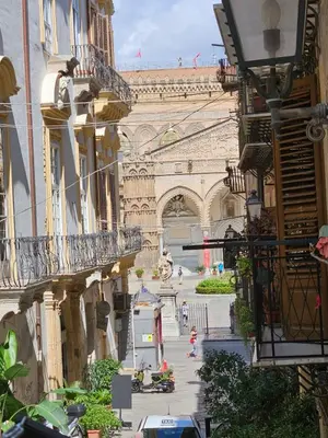 a view of the eiffel tower from between buildings at Casa Novelli 22 - Vista sulla Cattedrale in Palermo
