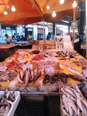a market with many different types of fish on display at Aura's Apartment in Palermo