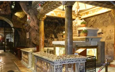 a large room with a fireplace in a building at Aura's Apartment in Palermo