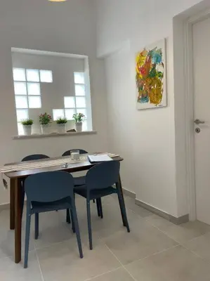 a dining room with a table and two chairs at Coralìa in San Vito lo Capo