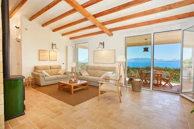 a living room with a couch and a table at Villa Lo Zingaro - Scopello-Villas in Scopello