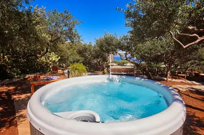 a large bath tub in a yard with trees at Villa Lo Zingaro - Scopello-Villas in Scopello