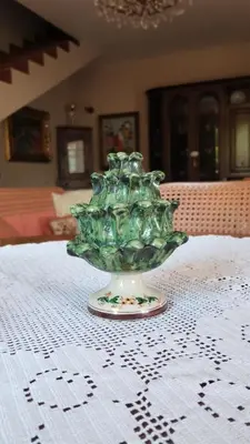 a green glass vase sitting on top of a table at Casa Berta in Mondello