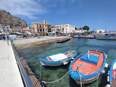 two boats tied to a dock in a harbor at Casa Berta in Mondello