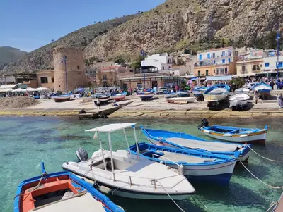 a group of boats are docked in the water at Casa Berta in Mondello