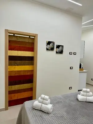 a bedroom with a bed with towels on it at Casetta Philia - Castellammare del Golfo in Castellammare del Golfo