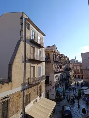 a view of a street with a building with a balcony at La dimora del MARCHESE NOTARBARTOLO in Palermo