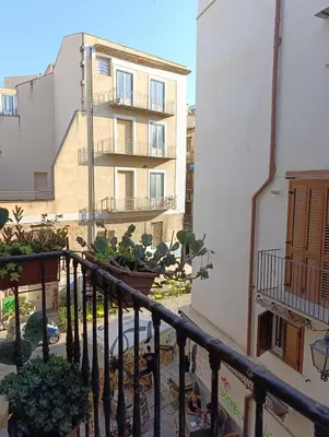 a balcony of a building with potted plants at La dimora del MARCHESE NOTARBARTOLO in Palermo