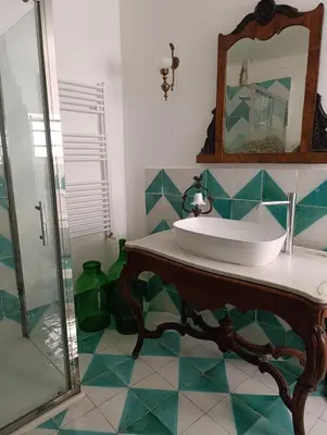 a bathroom with a sink and a mirror at La dimora del MARCHESE NOTARBARTOLO in Palermo