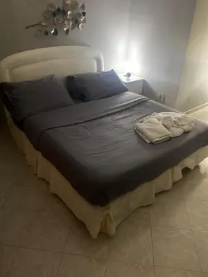 a large bed with blue sheets and blue pillows at Giuse home in Palermo